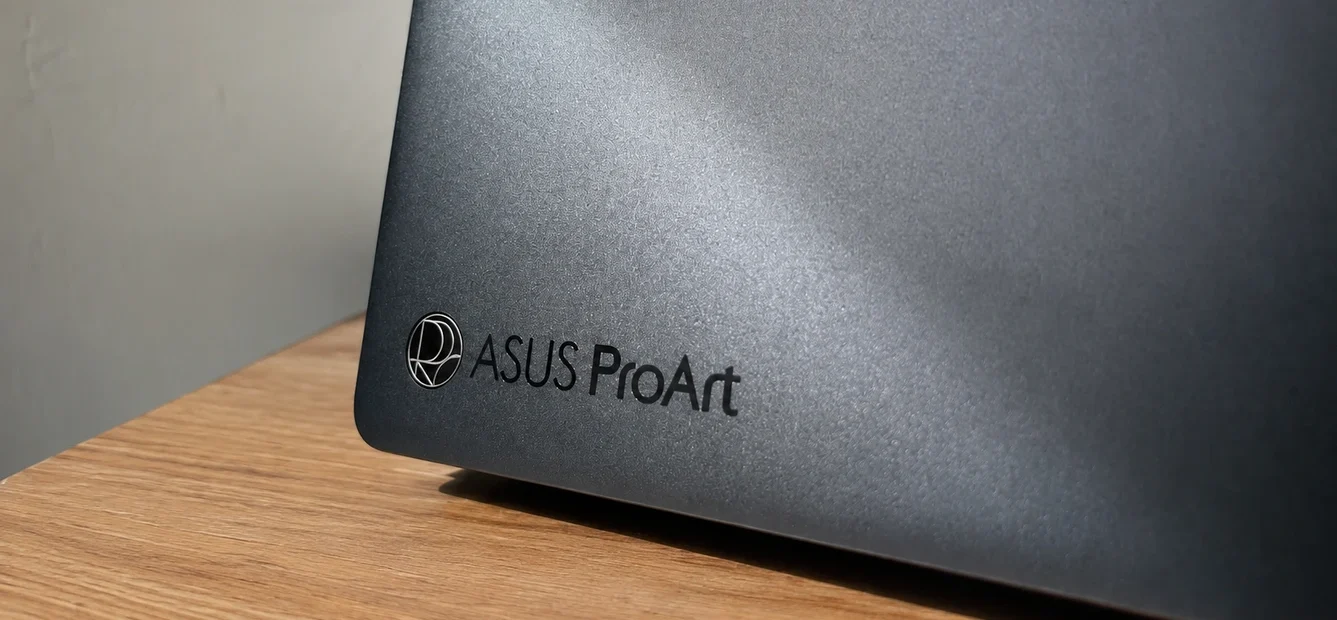 ASUS ProArt P16 lid close-up showing nano black finish on wooden desk