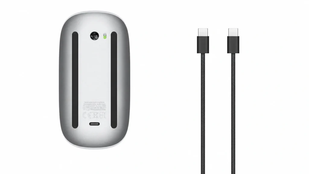 Apple Magic Mouse underside showing the USB-C charging port alongside the included USB-C charging cable.